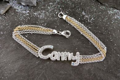 Armschmuck Weiss-Gelbgold 750, mit weissen und 2 blauen Brillanten 